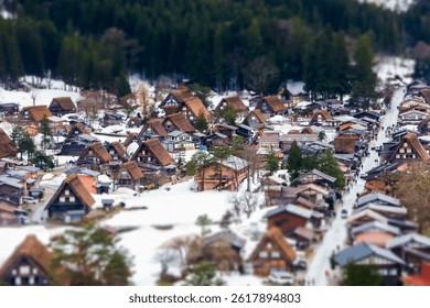 Nestled in a serene landscape, a traditional Japanese village displays charming thatched-roof houses blanketed in snow. Families stroll along winding paths, embracing winter's beauty.