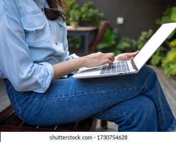 Net Idol Or Blogger Freelancers With Laptops Working In Garden At Home And Connecting To Internet Via Laptop.  Review Writting New Product And New Article.