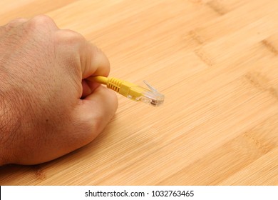 A net neutrality concept image consisting of an internet (ethernet) cable being held by a human hand. This image can also be used to represent internet censorship. 