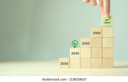 Net Zero By 2040. Carbon Neutral. Sustainalble Development. Successful Execution Of Green Business. Goal Checked In 2040. Go Green Company Culture. Hand Puts Wooden Cube With Net Zero Icon, Copy Space