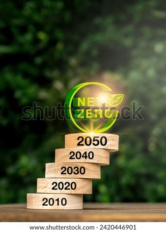 Net zero by 2050. Reduce CO2 emissions, carbon dioxide reduction, limit climate change, global warming concept. 3d Net Zero icon on round wood blocks stack with 2010 to 2050 years on wood background.