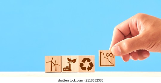 Net Zero And Carbon Neutral Concept. Wooden Cubes With Icons - Renewable Energy, Co2 Emissions Reduction, Green Production, Waste Recycling.