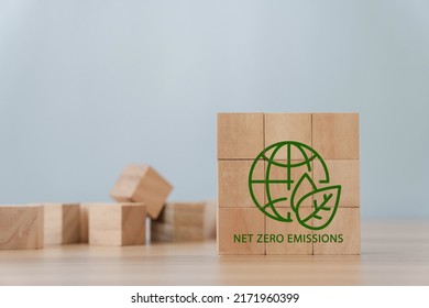 Net Zero And Carbon Neutral Concepts Net Zero Emissions Goals A Climate-neutral Long-term Strategy Green Net Center Icon On Wooden Block And World Record Icon On Gray Background