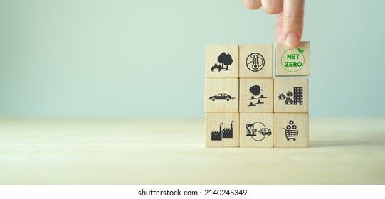 Net Zero Target And Carbon Neutral. Green Business Concept. Climate Changing Problems Solving Goals.
Stacking Wooden Cubes With Net Zero Icon On Pollution Source Icon On Grey Background And Copy Space