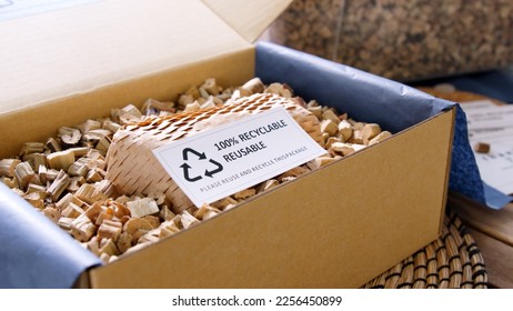 Net zero waste go green SME use eco friendly care sign plastic free symbol packaging carton box wrap paper in small shop retail store. Chva dried water hyacinth on desk reuse packing parcel supplies. - Shutterstock ID 2256450899