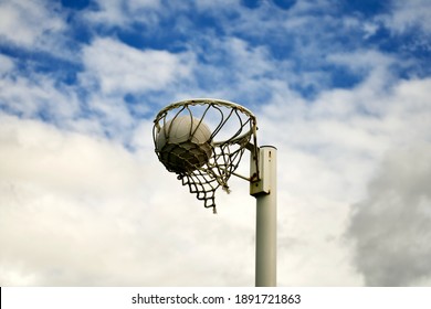 A Netball Ball Inside The Net Showing A Goal Scored