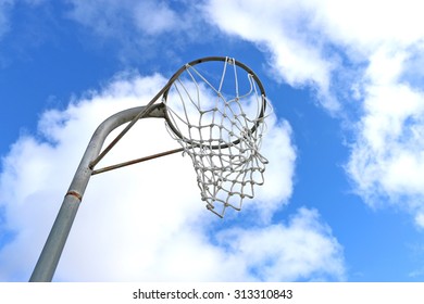 Netball Goal Ring And Net Against A Blue Sky And Clouds