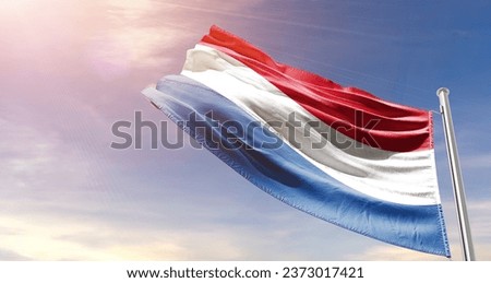 Netherlands national flag waving in beautiful sky. The flag waving with dynamic angle.