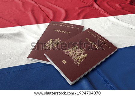 Netherlands passport on the Dutch flag ,Dutch passports are issued to citizens of the Kingdom of the Netherlands for the purpose of international travel.