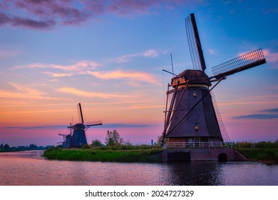Netherlands rural lanscape with windmills at famous tourist site Kinderdijk in Holland on sunset with dramatic sky