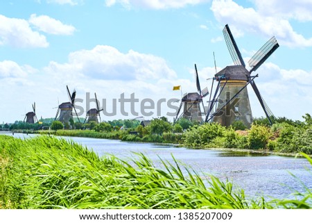 Netherlands rural lanscape with windmills at famous tourist site Kinderdijk in Holland. Old Dutch village Kinderdijk, UNESCO world heritage site. 