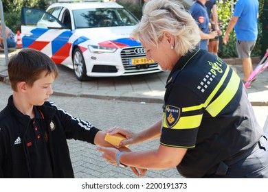 Netherlands, Sept1, 2022 - Police Officer Is Making A Police Fake Tattoo On Arm Of A Child During 112 Day In The Netherlands