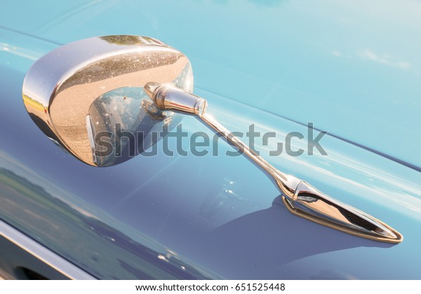 NETHERLANDS - VUGHT - MAY\
20, 2017: Car mirror of a Peugeot 404 classic car at the\
Lions-Kiwanis VCCR\
rally.