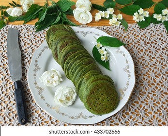 Nettles green pancakes with rose petals, cooking organic food with weed