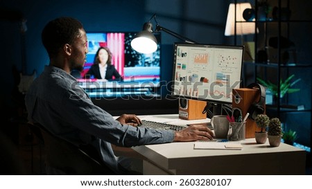 Network analyst studying digital commerce progression reports on computer, working at home to boost earnings and gain shareholder backing. Specialist analyzes company information. Camera A.