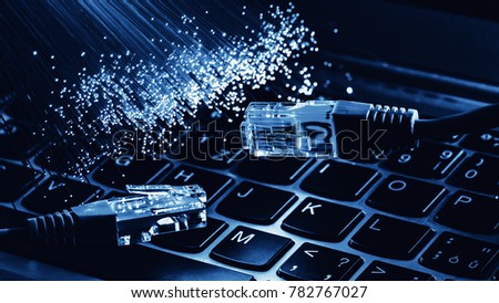 network cable closeup with fiber optical background, color fiber optical background with notebookk, Fiber optics lights abstract background