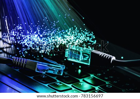 network cable closeup with fiber optical background, color fiber optical background with notebookk, Fiber optics lights abstract background