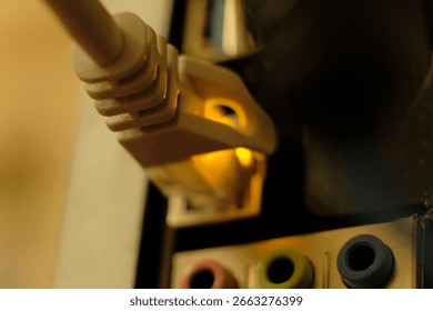 Network cable connector inserted into vibrant port with blue slots, illuminated by warm, golden glow. The background is blurred to highlight the secure and reliable connectiontech networking