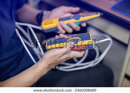 Network cable tester. Testing structured cabling using qualified cable performance tester. UTP cable with RJ45 jack checking with digital cable tools.
