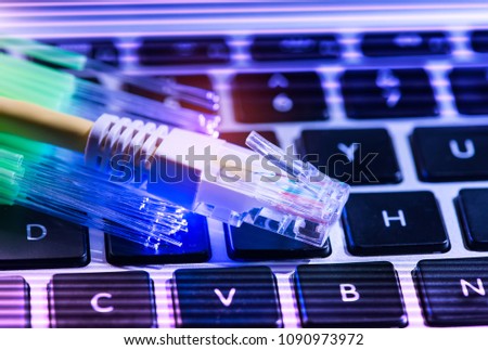 network cables and fiber optic closeup with keyboard background