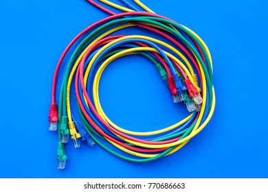 Network colored cables for computer on blue background top view