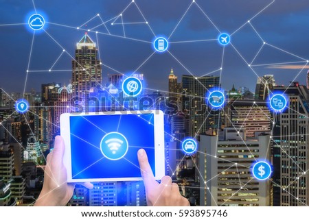 Network of connect digital tablet with wireless communication network, business district with office building, abstract image visual, internet of things concept.
