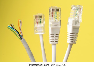 Network connection, internet connection and computer technology concept, close-up of ethernet cable connector, on yellow background