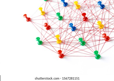 Network connection made from push pins and thread on blue background, close-up. 