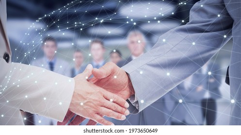 Network Of Connections Over Two Businessmen Shaking Hands Against Business People Standing. Global Networking And Business Technology Concept