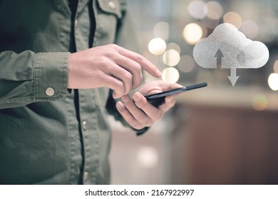 Network data cloud. A man holds a phone in his hand and presses the screen