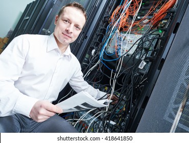 network engineer administrating in server room  - Powered by Shutterstock