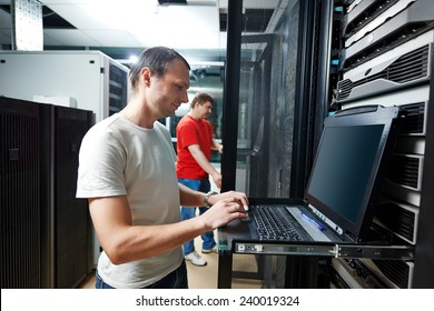 Network Engineer Working In Server Room