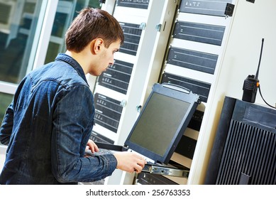 Network Engineer Working In Server Room