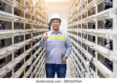 Network engineer working with tablet  in server data center room, professional skilled technician