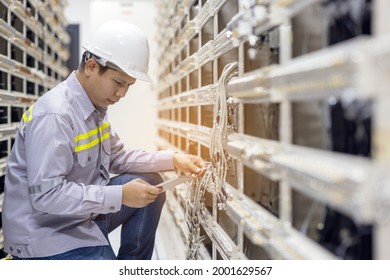 Network engineer working with tablet  in server data center room, professional skilled technician