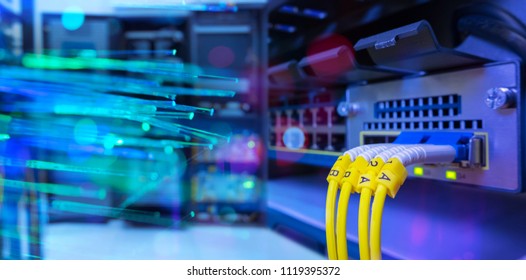 network gigabit switch and fiber optic cable and lighting of fiber optics on background in data center room