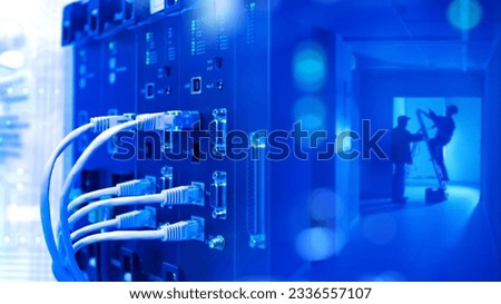 Network hardware. Internet technology. Wires are connected to network equipment. Workers with ladder in distance. Internet tech. Specialists configure network equipment. Telecommunication systems