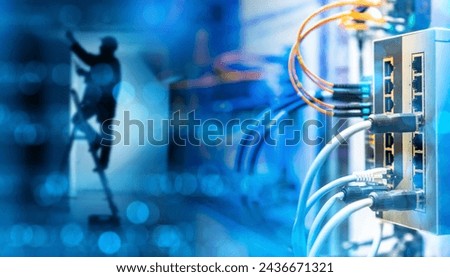 Network hardware. Man is electrician. Network switch with wires. Internet equipment inside building. Concept for setting up telecommunications equipment. Switch with fiber optic wires.
