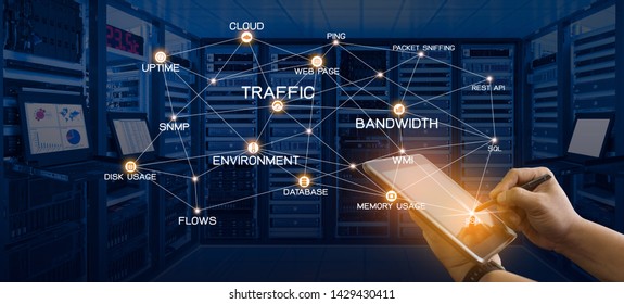 Network Monitoring Concept Of Administrator Holding Tablet Computer With Pen And Connection Of Monitoring Services And Data Center Room With Server, Networking Devices And Kvm Monitors