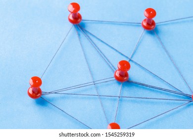 Network With Red Pins And String, An Arrangement Of Colorful Pin