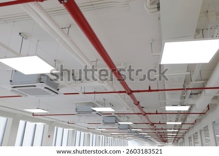 A network of red pipes in the ceiling for fire extinguishing