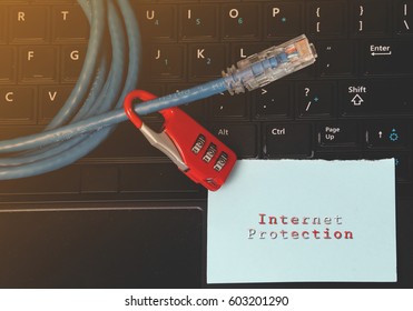 Network Security- Information, connection, communication, and technology security concept. Network cable and red padlock with notes written INTERNET PROTECTION.