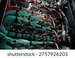 Network server rack showing multiple rows of connected ethernet cables and blinking indicator lights, illustrating data center infrastructure and high speed internet connectivity