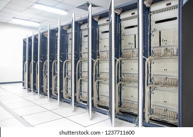 Network server room with Close rack is row in white floor and white ceiling , high performance computers running processes , Rack is open door show telecommunication technology