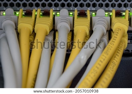 Network switch close up with yellow and gray cables
