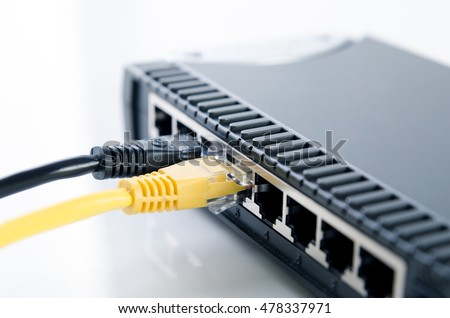Network switch device and ethernet cables on white background
