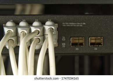 Network switch and ethernet cable in rack cabinet. Network connection technology thrue cat6 and cat5 wires. Network switch and cables.