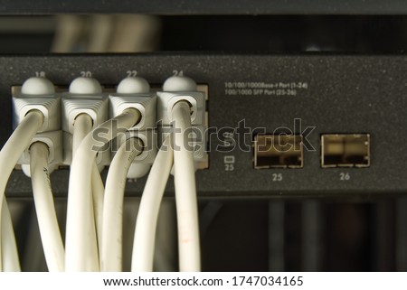 Network switch and ethernet cable in rack cabinet. Network connection technology thrue cat6 and cat5 wires. Network switch and cables.