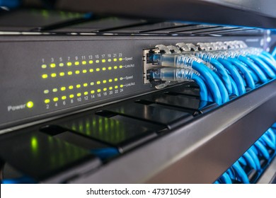 Network Switch And Ethernet Cables In Rack Cabinet