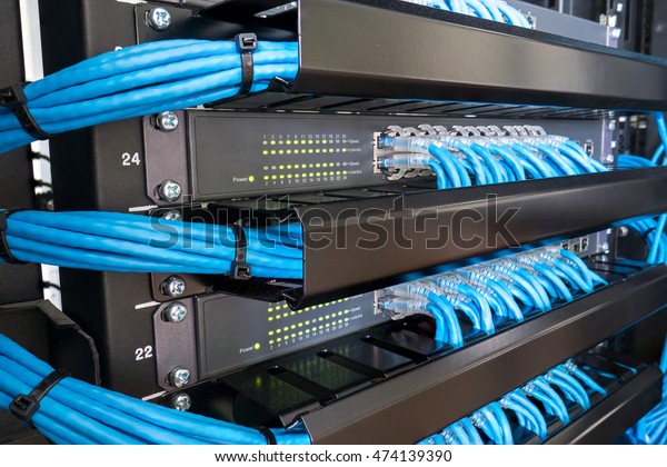 Network Switch And Ethernet Cables In Rack Cabinet
